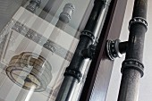 Ornate metal pillar reflected in window