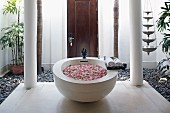 Basin filled with rose petals in courtyard of Oriental spa hotel