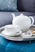 A teacup, teapot, plate and sugar bowl on a tray