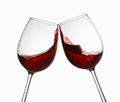 Glasses of red wine being clinked together