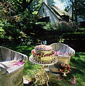 A Woodland Cake with Butterfly Decorations on a Small Outdoor Table