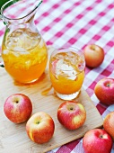 A Pitcher and Glass of Organic Fuji Apple Juice with Fresh Organic Fuji Apples
