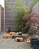 Contemporary Japanese-style courtyard - tea ceremony on improvised table and floor cushions on gravel floor