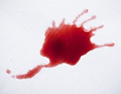 A red wine spillage on a table cloth