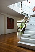 Detail of white metal staircase in open-plan interior