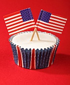 A cupcake decorated with US flags
