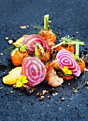 A salad of beetroot, carrots, herbs and prawns