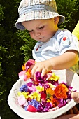 Baby playing with basket of flowers