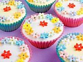 Cupcakes decorated with colourful sugar flowers