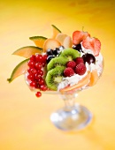 Fruit dessert with whipped cream and biscuits
