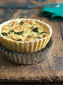 Individual Broccoli and Cheese Quiche On Top of Baking Tin
