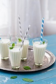 Four glasses of ayran yoghurt drink with salt and fresh mint