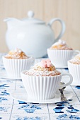 Muffins baked in silicon teacups on a Dutch tablecloth