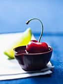 A cherry in alcohol in a tiny bowl made of chocolate