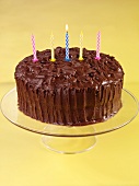 Devil's food cake (chocolate layer cake, USA) with birthday candles