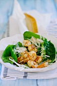 Fried prawns with spinach salad