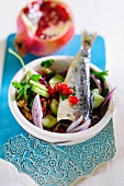 Mixed salad with pomegranate and herring