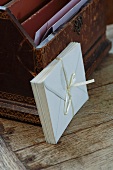 Envelopes bound with silk ribbon leaning on antique letter rack