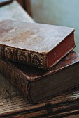Antiquarian books with gilt embossing on worn leather bindings