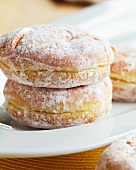 Powdered Jelly Doughnuts on a White Dish