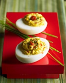 Two Deviled Eggs on Red Pedestal Dish