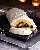 Swiss roll filled with blueberry jam and covered in cream