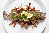 Fried trout on skinny chips (overhead shot)