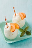 Peach smoothies with drinking straws