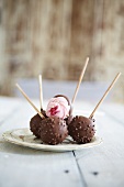 Chocolate lollies with chopped nuts and buttercream