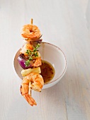A prawn and asparagus skewer with chilli sauce