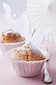 Muffins decorated with icing sugar and angel's wings