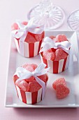 Heart-shaped fruit jellies in muffin cases as gifts for guests