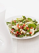 A salad of fish, avocado, pepper and lemon