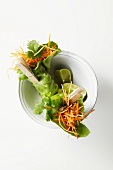 Grated carrot wrapped in lettuce leaves