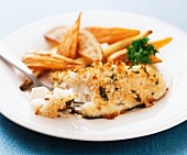 Fish fillet with a herb crust and roasted carrots and parsnips