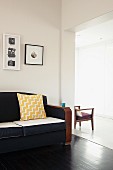 Framed pictures above retro sofa in living room