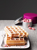 Waffles with pink pralines and icing sugar