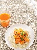 Couscous with carrots and pumpkin, and a glass of carrot and orange juice