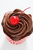 Chocolate cupcake topped with a cherry