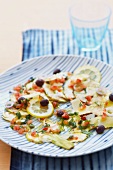 Artichoke carpaccio with olives and lemons
