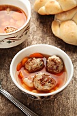 Vegetable broth with beans, carrots and meatballs