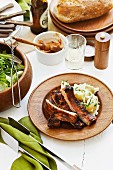 Barbecued pork chops with potato salad and bread