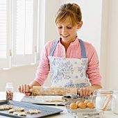 Teenaged girl baking cookies