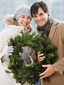 Couple holding wreath
