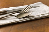 Close up of silver forks, knife and spoon on napkin