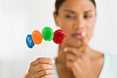 Woman holding colorful lollypops