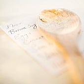 Wooden spoon on top of shopping list