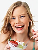 Woman eating fruit salad