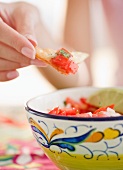 USA, New Jersey, Jersey City, Close-up view of woman's hand eating salad with cracker