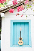 Brazil, Bahia, Trancoso, Guitar against building wall